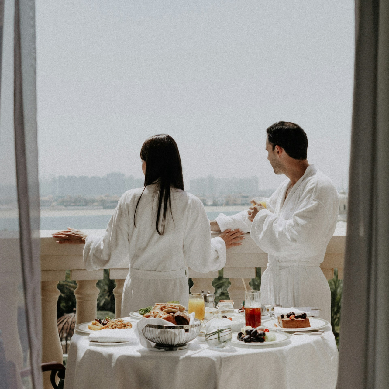 Couple admiring the view from a hotel balcony