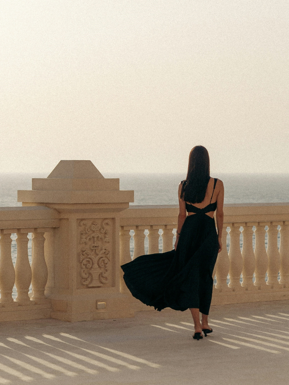 Woman on a balcony with an ocean view
