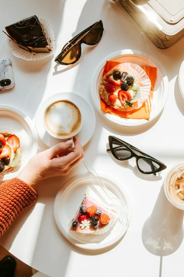 Woman enjoying a latte and pastries
