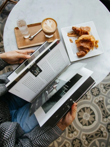 Woman flipping through a book at a cafe