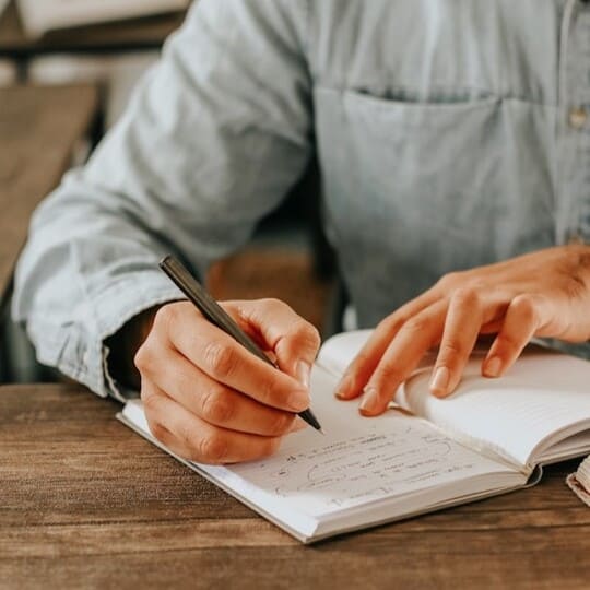 Man writing in a notebook