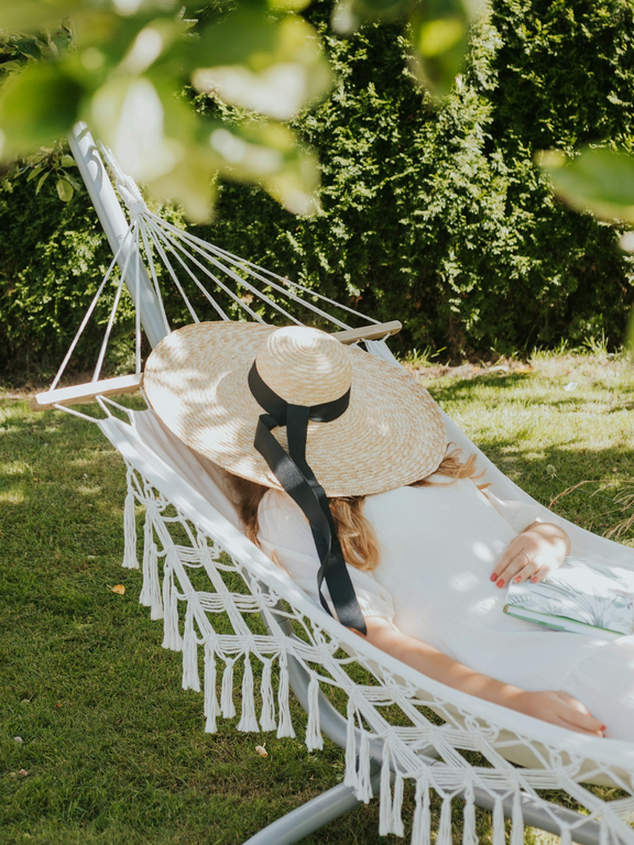 Woman resting in a hammock outdoors