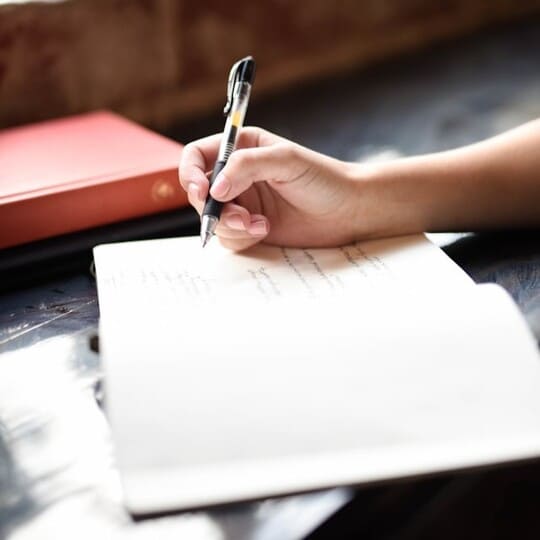 Woman writing in a journal