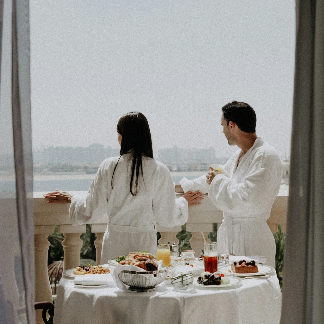 Couple admiring the view from a hotel balcony